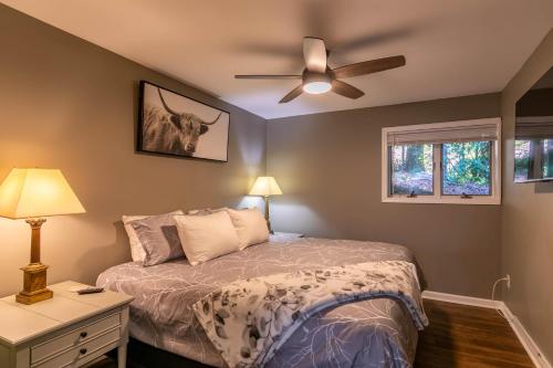 a bedroom with a bed and a ceiling fan at Fairway Gem at Spruce Pine in Spruce Pine