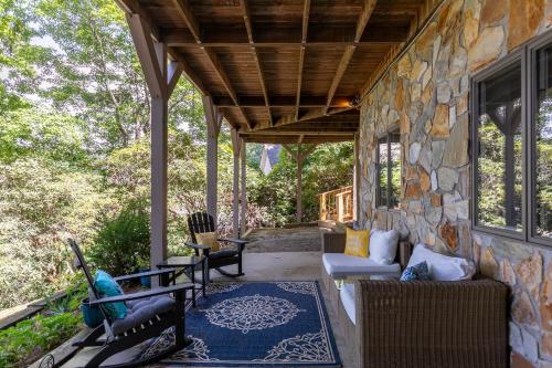 an outdoor living room with a stone wall at Fairway Gem at Spruce Pine in Spruce Pine