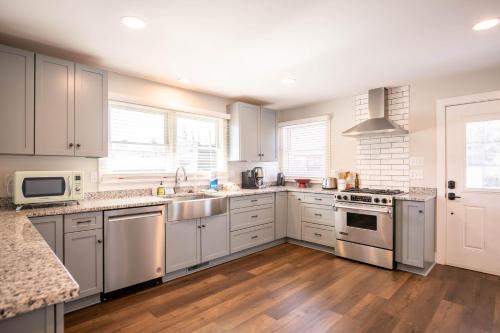 a kitchen with white cabinets and stainless steel appliances at Stella Maris in Blowing Rock