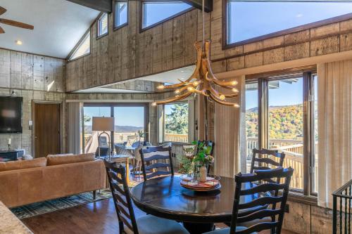 a dining room and living room with a chandelier at Hawk Haven in Banner Elk