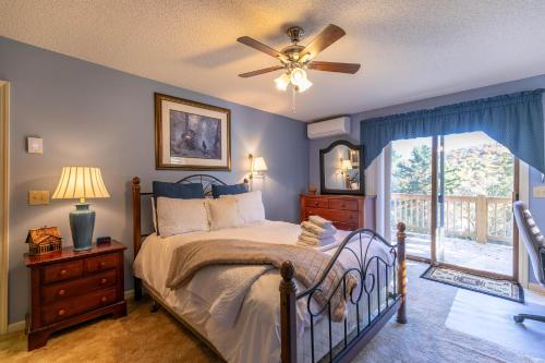 a bedroom with a bed and a ceiling fan at Hawk Haven in Banner Elk