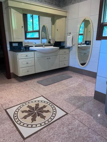 a bathroom with a sink and a mirror at Paparadise in Papara