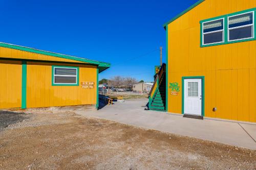 a yellow building with a door and a playground at Near ATV Trails Carlsbad Apt with Shared Fire Pit in Carlsbad