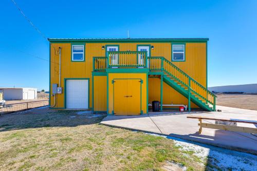a yellow building with a staircase in front of it at Near ATV Trails Carlsbad Apt with Shared Fire Pit in Carlsbad