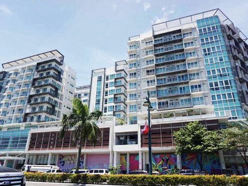 two tall buildings with cars parked in front of them at Tower 1 - One Madison Luxury Residences 5M in Mandurriao