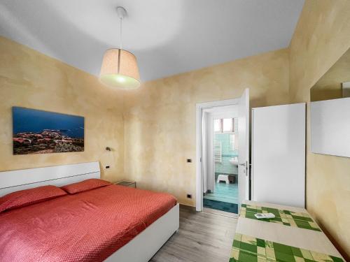 a bedroom with a red bed and a bathroom at House Rene in Agerola