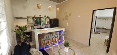 eine Küche mit einer Theke und eine Bar mit Hockern in der Unterkunft aldea isla sagrada in Cozumel