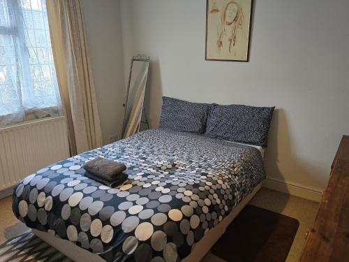 a bedroom with a bed with a comforter on it at Antonio's large double bedroom in Thornton Heath