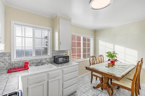 a kitchen with a table and a sink at 3 Bedroom 2 Bathroom House, Walkable to BART, Free Parking, Views in Daly City