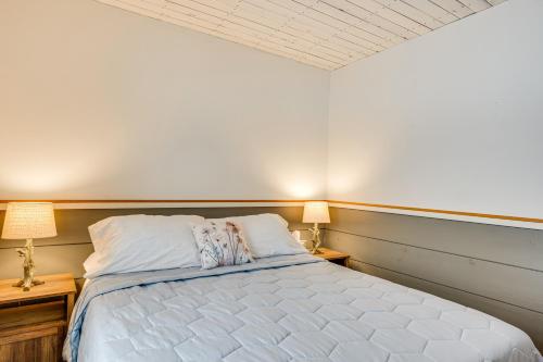 a bedroom with a large bed with two lamps at Ride From Your Door Cabin with VAST Trail Access! in Hardwick