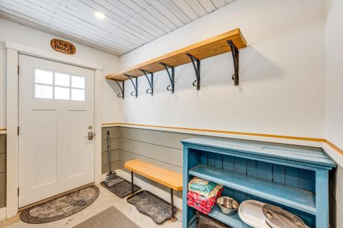 a bathroom with a blue cabinet and a door at Ride From Your Door Cabin with VAST Trail Access! in Hardwick