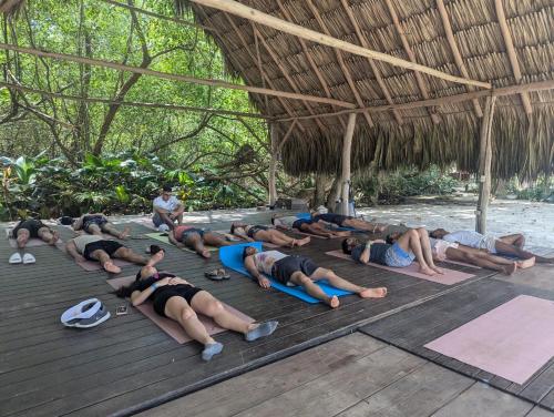 a group of people doing yoga on a deck at Viajero Tayrona Hostel & Ecohabs in Buritaca