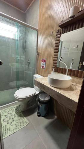 a bathroom with a toilet and a sink and a shower at POUSADA IRMAOS ATINS in Atins