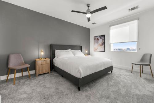 a bedroom with a bed and two chairs and a window at The Nomad ATL in Atlanta