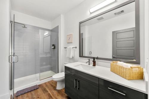 a bathroom with a sink and a shower and a toilet at The Nomad ATL in Atlanta
