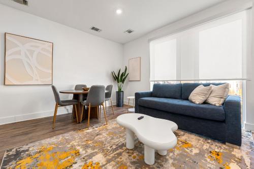 a living room with a blue couch and a table at The Nomad ATL in Atlanta