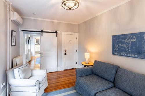 a living room with a couch and a chair at Paws on Pelham in Newport