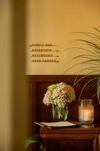 a vase of flowers sitting on top of a table at Daylesford Hotel in Daylesford