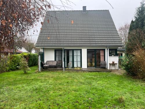 a small white house with a large yard at House in Rostock Gartenstadt in Rostock