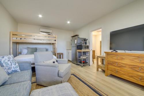 a living room with a bed and a flat screen tv at Deck with Water Views Quiet East Boothbay Retreat! in East Boothbay