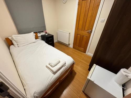 a bedroom with a bed with two towels on it at The Bell and Bottle in Hedgerley