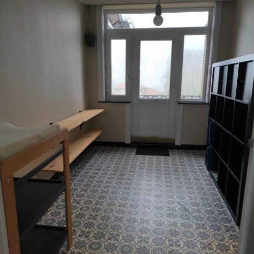 an empty room with a bench and a window at Hoge Weg in Oudenaarde