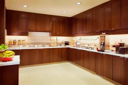 a large kitchen with wooden cabinets and a counter at Residence Inn by Marriott Tustin Orange County in Tustin