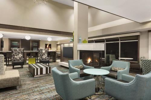 a lobby with chairs and a fireplace at Residence Inn by Marriott St. Paul Woodbury in Woodbury