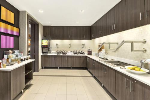 a large kitchen with wooden cabinets and appliances at Residence Inn by Marriott St. Paul Woodbury in Woodbury