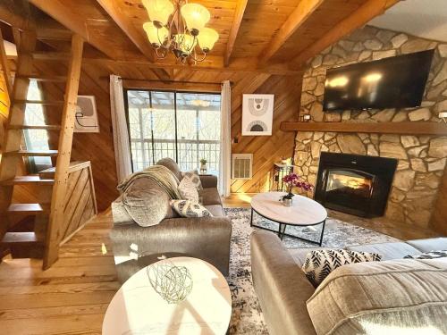 a living room with a couch and a fireplace at Plentiful Porches - Hot Tub - King Bed - Views in Banner Elk