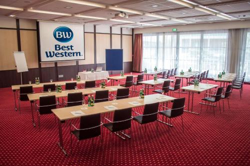 a group of tables and chairs in a large room at Best Western Plaza Hotel Wels in Wels