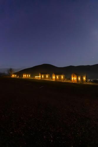 a row of houses in a field at night at Комплекс відпочинку Крихая in Solochin