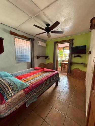 a bedroom with a bed and a ceiling fan at Hostal Hansi in Bocas del Toro