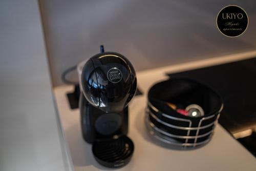 a black cup sitting on top of a counter at Miyaki Apartments - BJELASNICA in Bjelašnica