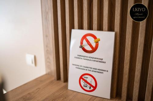 a sign with a no smoking sign on a wall at Miyaki Apartments - BJELASNICA in Bjelašnica