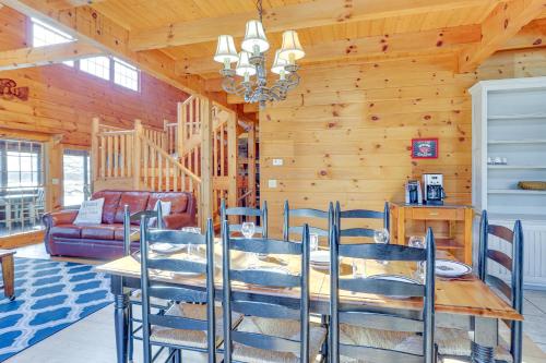 a dining room with a table and chairs in a cabin at Private Boat Ramp and Dock Kentucky Lake Cabin! in Camden