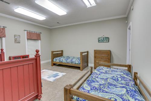 a room with two bunk beds and a bedroom with aintendent at Private Boat Ramp and Dock Kentucky Lake Cabin! in Camden