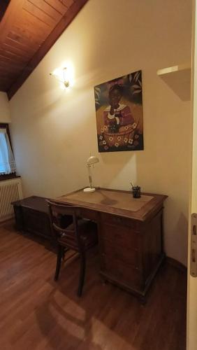 a desk in a room with a painting on the wall at Sottocastello 2 in Gorizia