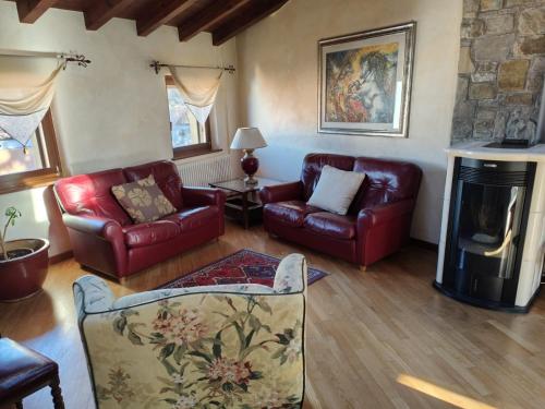 a living room with leather furniture and a fireplace at Sottocastello 2 in Gorizia