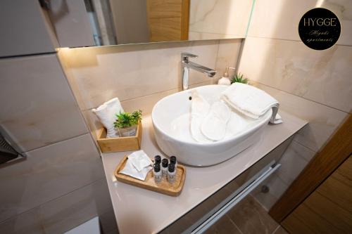 a bathroom with a white sink on a counter at Miyaki Apartments - BJELASNICA in Bjelašnica