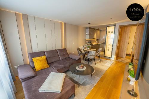 a living room with a couch and a table at Miyaki Apartments - BJELASNICA in Bjelašnica