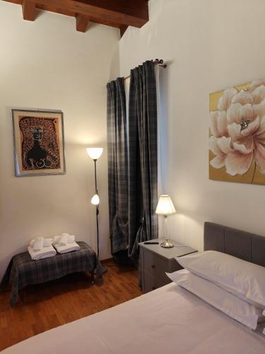 a bedroom with a white bed and a flower painting on the wall at Sottocastello 2 in Gorizia