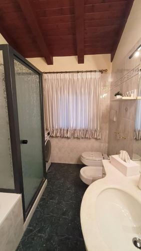 a bathroom with two toilets and a sink and a shower at Sottocastello 2 in Gorizia