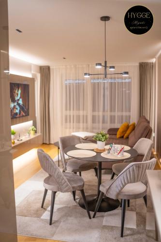 a living room with a table and chairs at Miyaki Apartments - BJELASNICA in Bjelašnica
