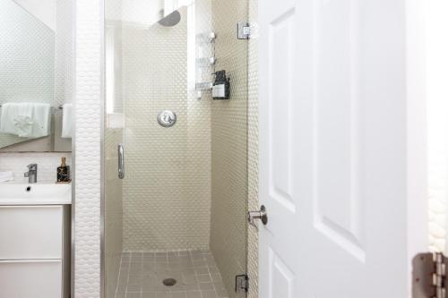 a shower with a glass door in a bathroom at Riviere South Beach Hotel in Miami Beach
