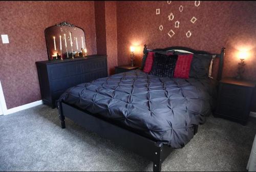 a bedroom with a large bed with two night stands at Vintage Queen Suite - 7 mins From ATL Airport in Riverdale