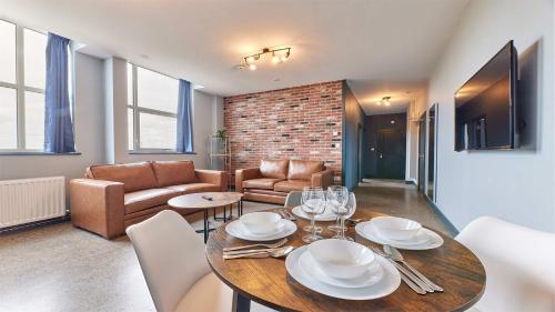 a living room with a table and a couch at Apartment Stays in Newcastle upon Tyne