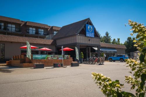 a store with red umbrellas in a parking lot at Sea to Sky Hotel and Conference Centre in Squamish