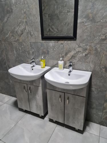 a bathroom with two sinks and a mirror at Bethlehem Guest House in Bethlehem