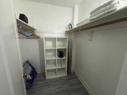 a walk in closet with white shelving at Family Stay Ocean Reserve Resort Sunny Isles in Sunny Isles Beach